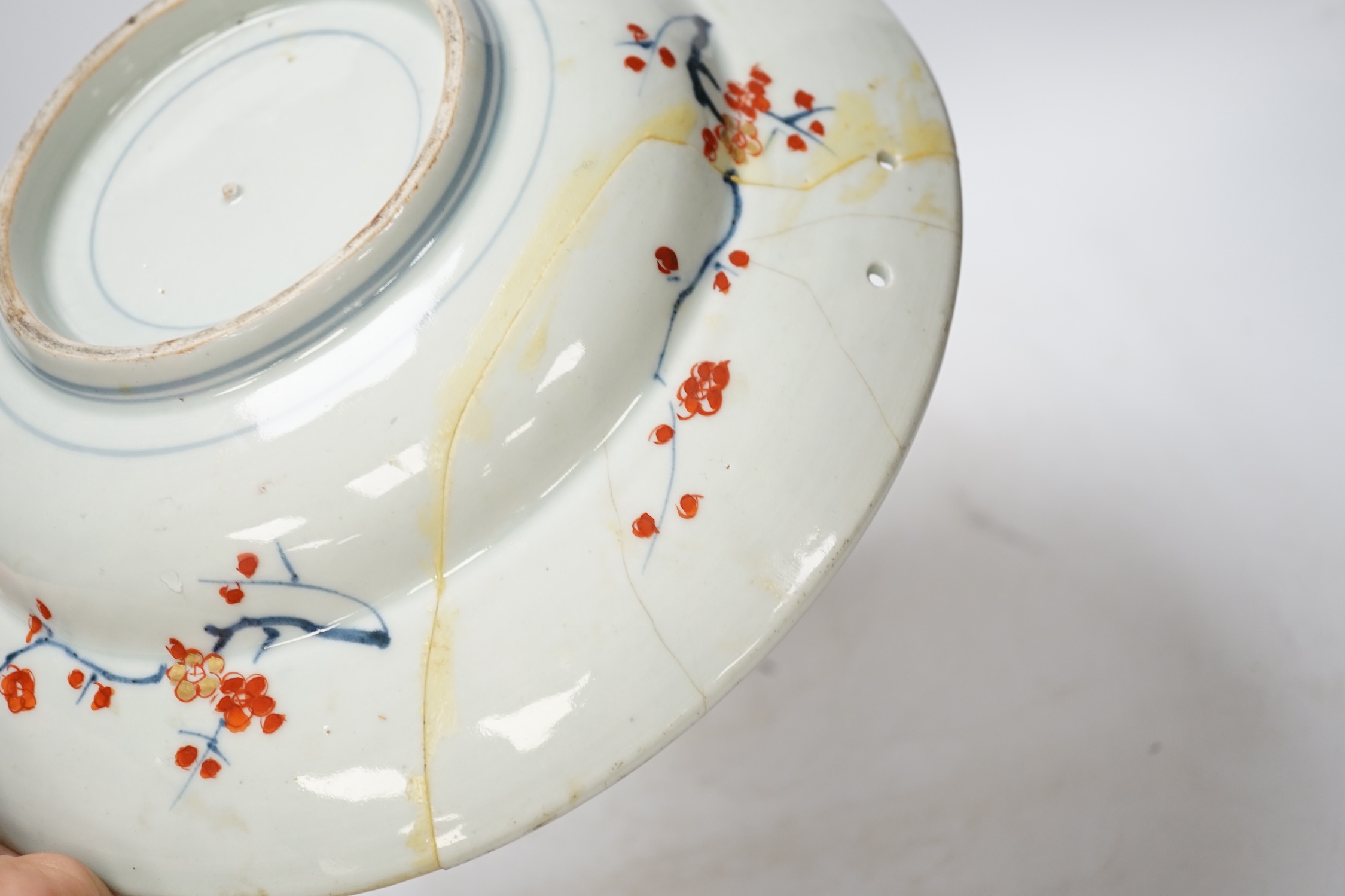 A Japanese Arita ‘cranes and chicks’ barber's bowl, early 18th century, in Imari palette, 27.5cm diameter. Condition - poor (a.f.)